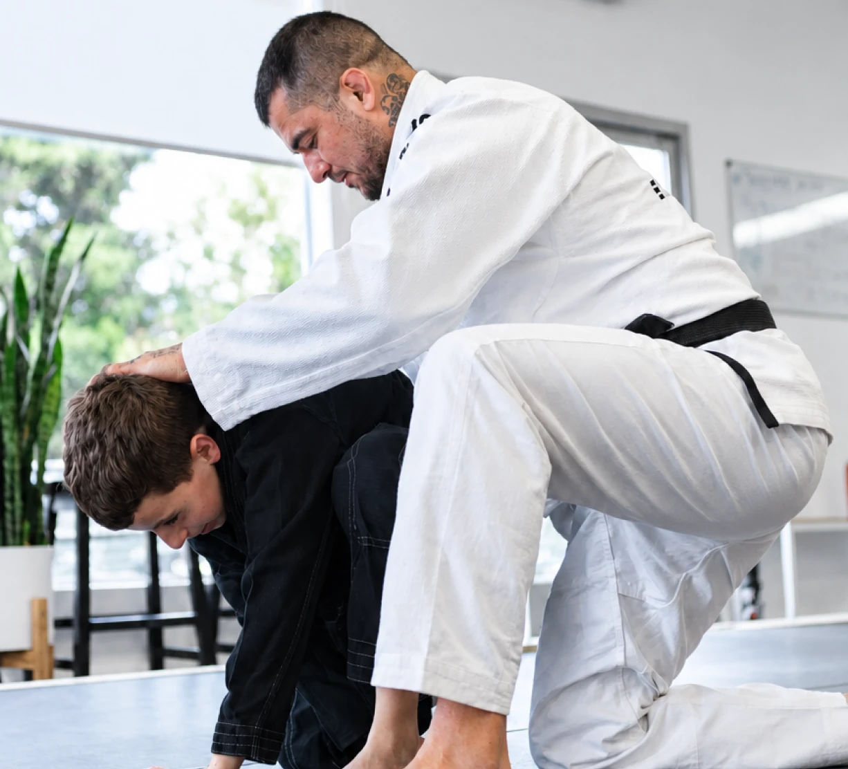 Young student receiving technical mentorship during private martial arts training at Essence BJJ Walnut Creek